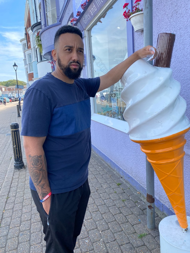 Tommo leaning against a giant ice cream cone in 2025